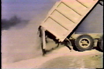 A truck dumping a load of cement.