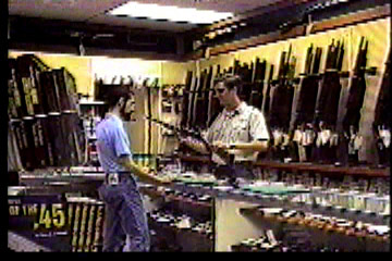 Inside sporting goods store at gun counter