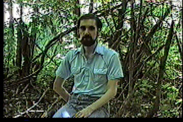 Steve sitting in woods where he once tried hunting