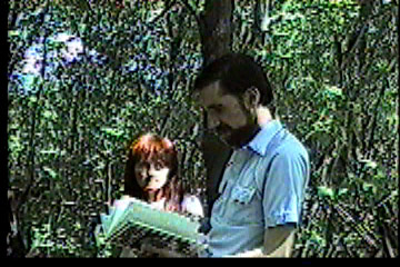 Steve leafing through the book 'The American Hunting Myth' with Sharon looking on